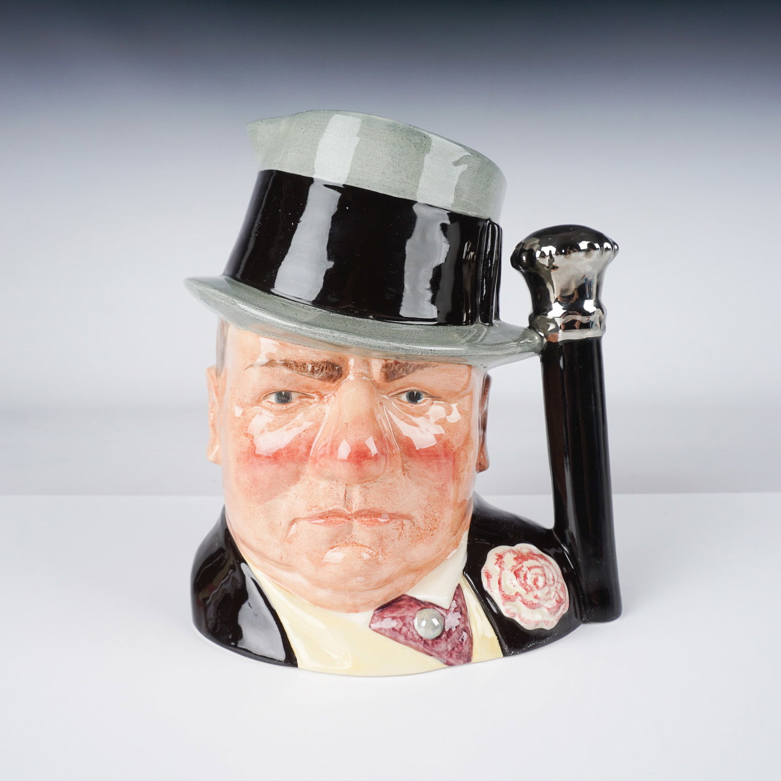 Royal Doulton Large Character Jug, W.C. Fields D6674: Part of the Celebrity Colelction. This Royal Doulton large character jug features the iconic American comedian and actor W.C. Fields. Designed with Fields' recognizable top hat and cane, this piece ca