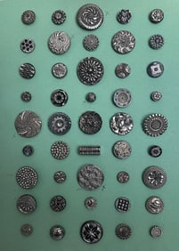 A card of div.1 black glass buttons with silver luster