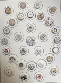 A card of division three glass buttons.