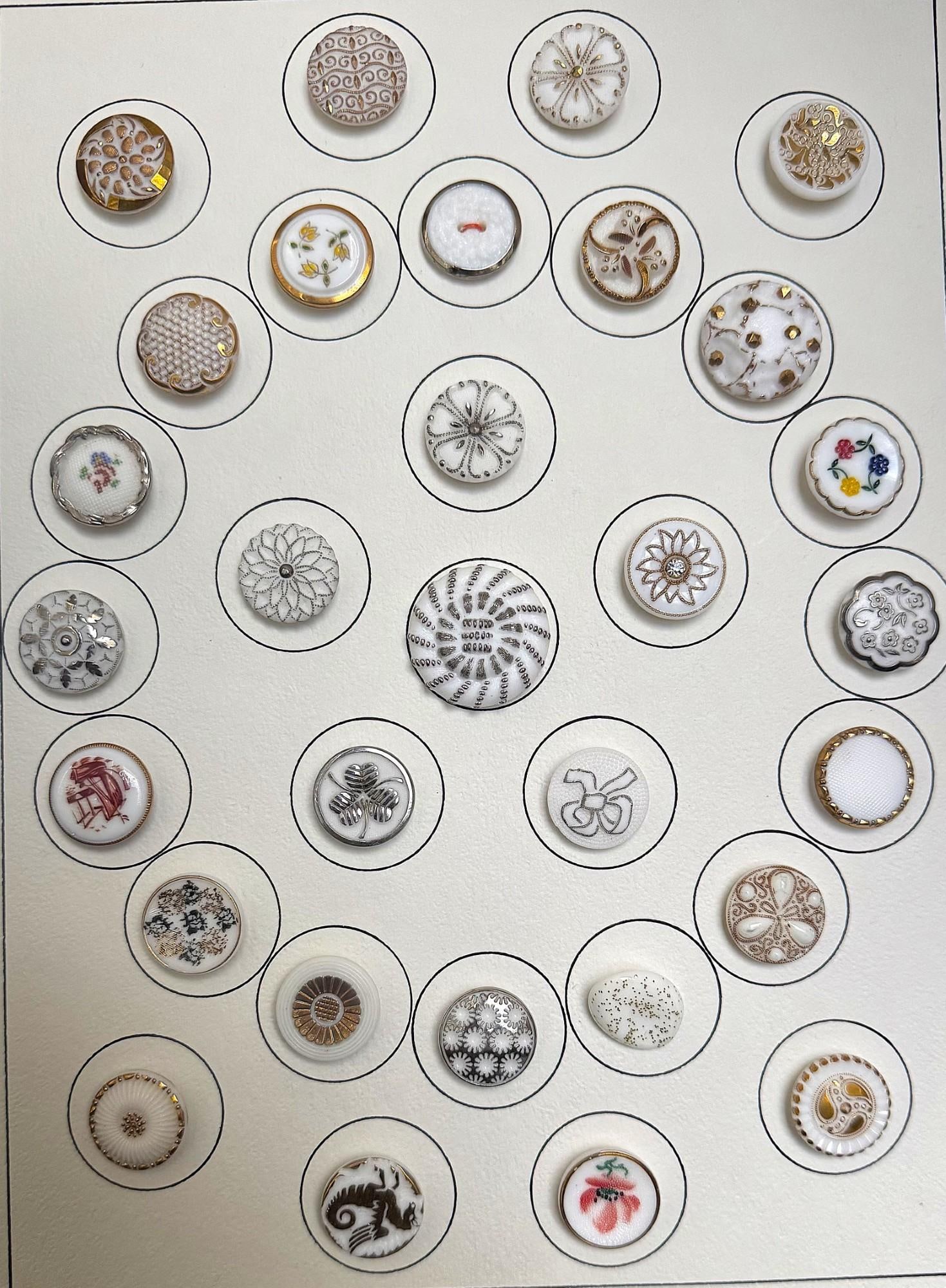A card of division three glass buttons. (1 of 3)