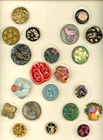 A card of division three colorful plastic buttons