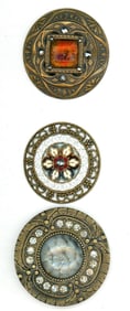 A small card of glass in metal buttons