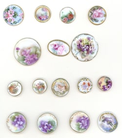 A card of division one hand painted porcelain buttons