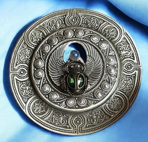 A division three pierced metal scarab button
