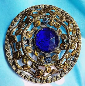 A division one glass in metal button
