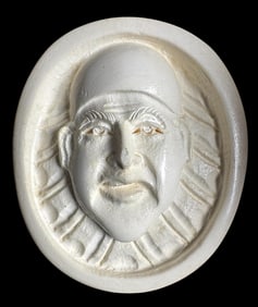 A division three carved white material pictorial button