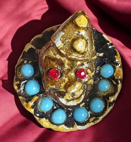 A division three pictorial plaster button