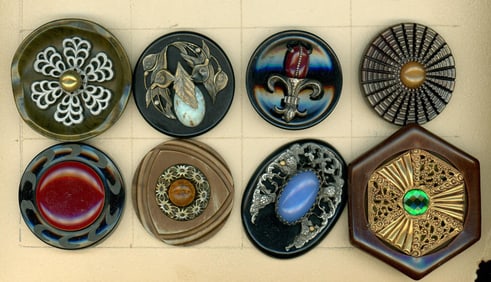A partial card of division three Bakelite buttons