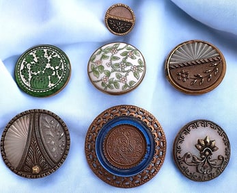 A small card of Division one glass in metal buttons