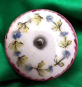 A division one hand painted ceramic button