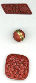 A small card of division one Cinnabar buttons