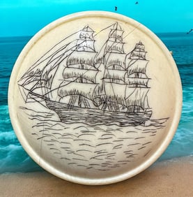 A hand crafted engraved natural material button