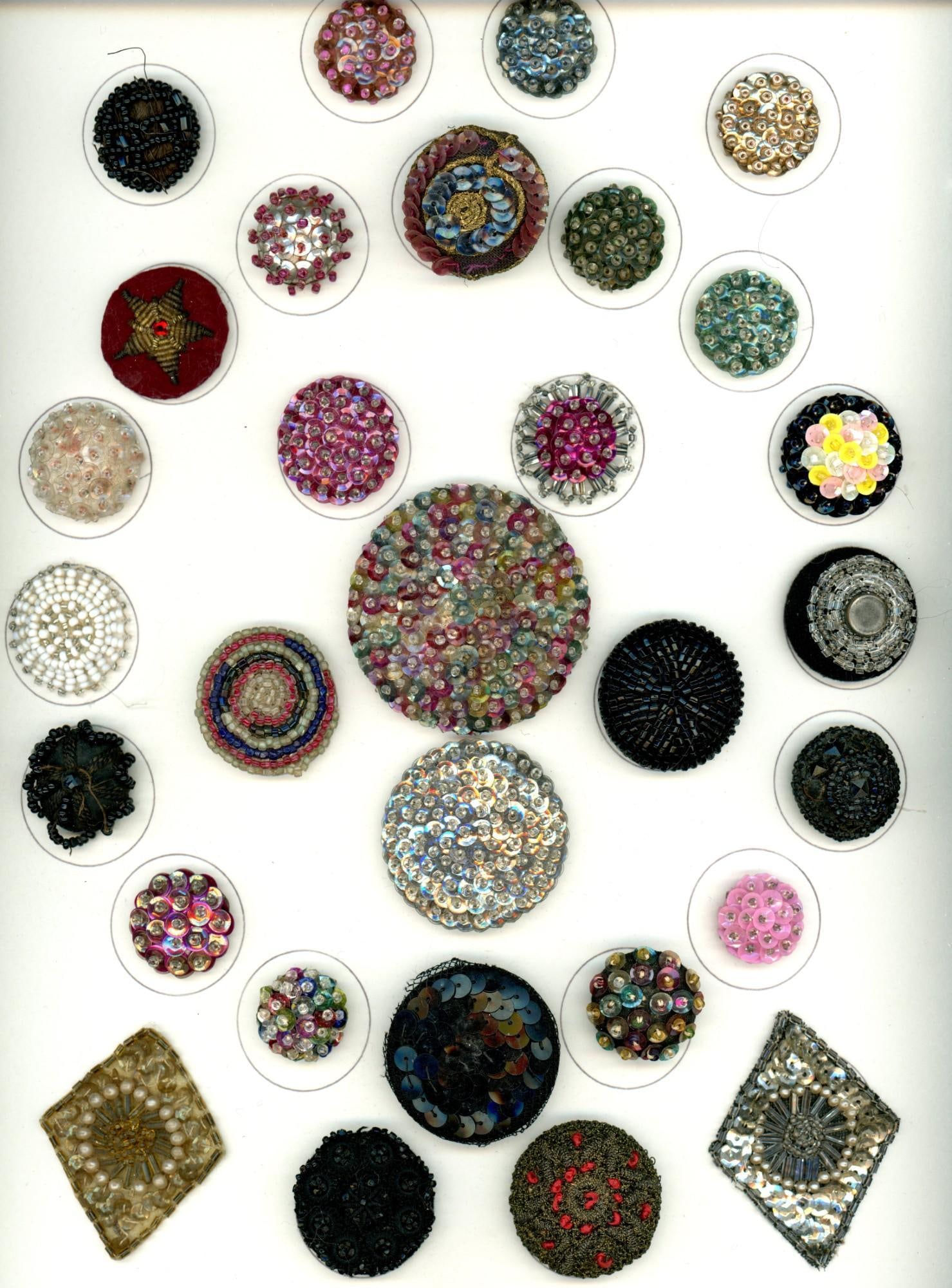 A card of division 1 & 3 "Glitzy" fabric buttons: 30 Med/Lg 19th-20th C. examples specialized to sequins & beads. Here is a beautiful card of fabrics with sequins and or beads, Notice the big rainbow colored example and the brilliant silver example a