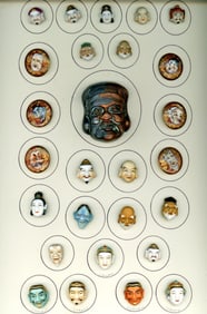 A card of division three ceramic masks and god buttons