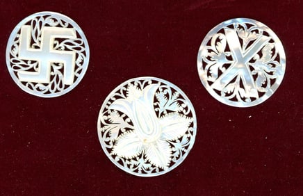 A small card of division three pierced pearl buttons