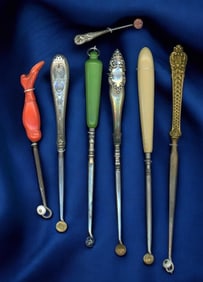 A small selection of old shoe button hooks.