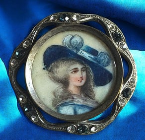 A division one hand painted under glass button