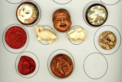 A small card of division three assorted Asian buttons.