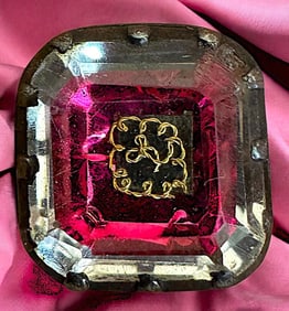 A division one crystal in silver shaped button