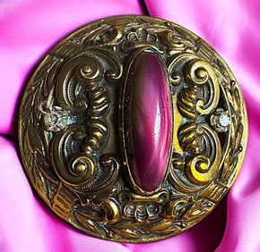 A division one glass in metal button