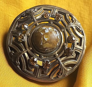 A division one glass in metal button