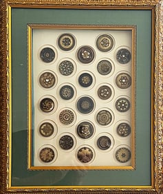 A framed card of division one celluloid buttons
