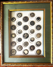 A framed card of division one celluloid buttons
