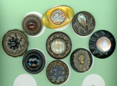 A partial card of division three Bakelite buttons