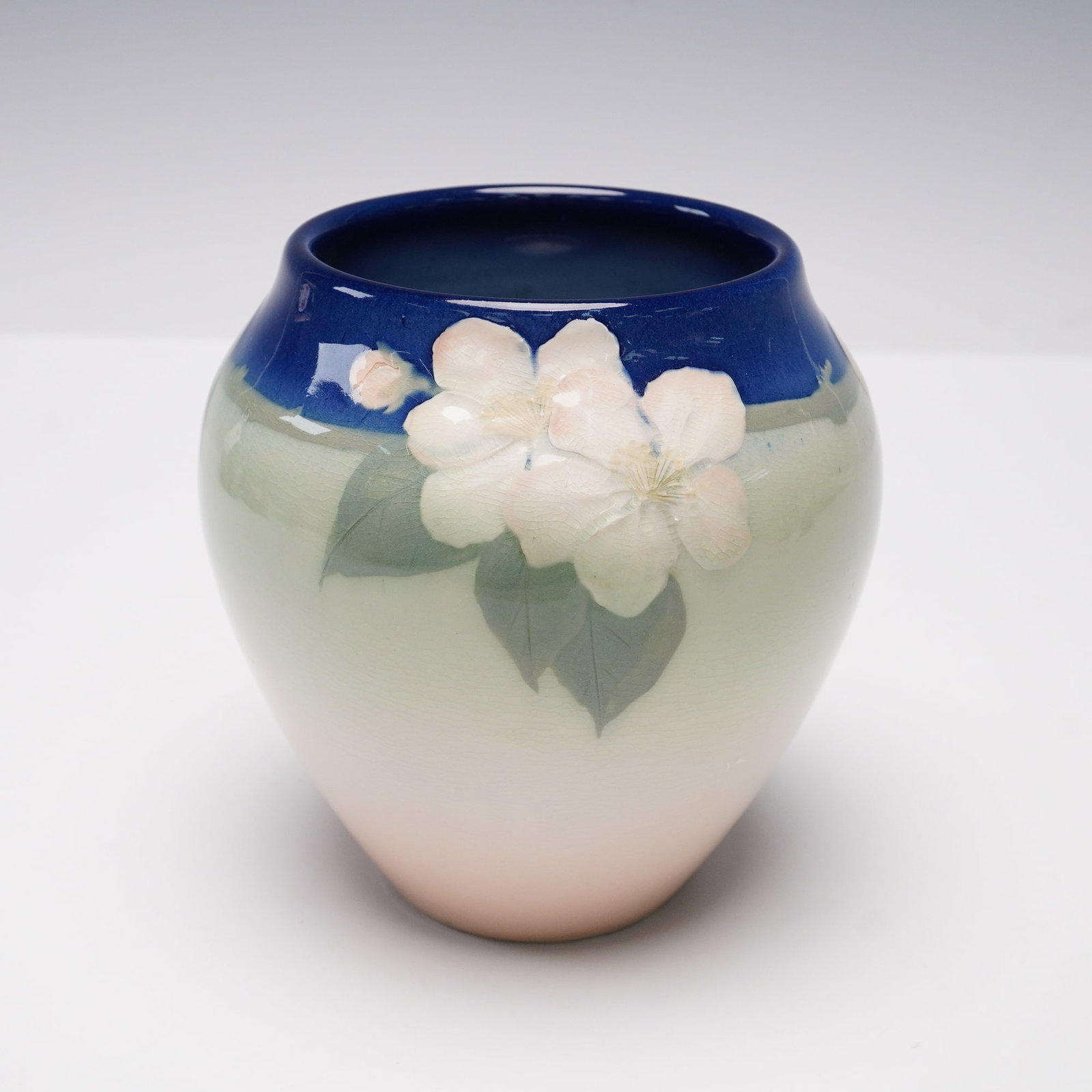 Rookwood Pottery Iris Glaze Vase 1343: A finely crafted Rookwood Pottery vase in the desirable Iris glaze, shape number 1343, decorated by Elizabeth Lincoln with delicately rendered floral motifs in soft pastel tones beneath a luminous tra