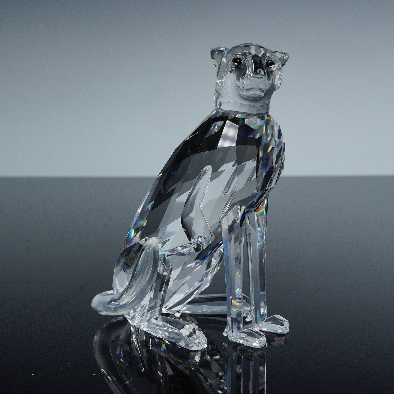 Swarovski African Wildlife Crystal Figurine, High Tail Cheetah: This exquisite sculpture captures the poised elegance of the cheetah in faceted clear crystal, with meticulously cut surfaces that reflect and refract light for a brilliant display. The piece features