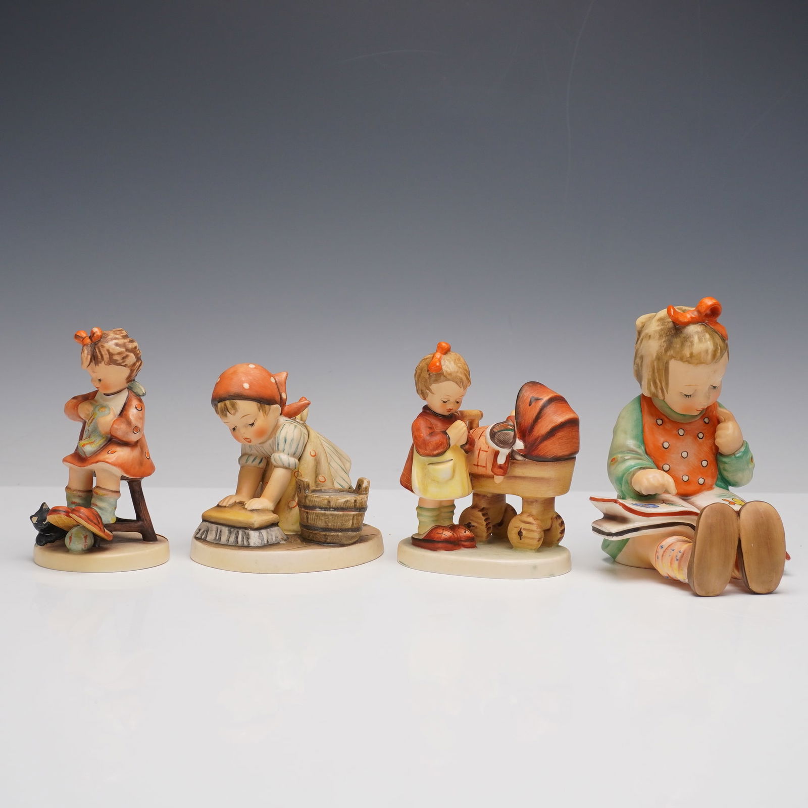 4pc Goebel Hummel Figurines: This delightful set features four classic Hummel figurines capturing sweet everyday scenes. Big House Cleaning shows a young girl scrubbing the floor beside a wooden bucket. Mothers Helper depicts a c