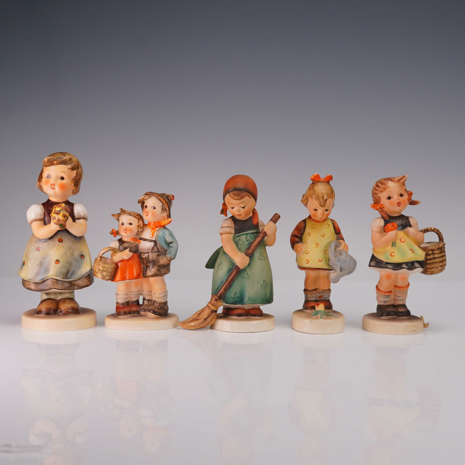 5pc Goebel Hummel Childhood Figurines, Little Sweeper, For Mother, and More: Lot of five Goebel Hummel porcelain figurines depicting charming childhood scenes. Includes: For Mother (257) featuring a young girl holding flowers, Sister (98/2/0) with two children together, Little