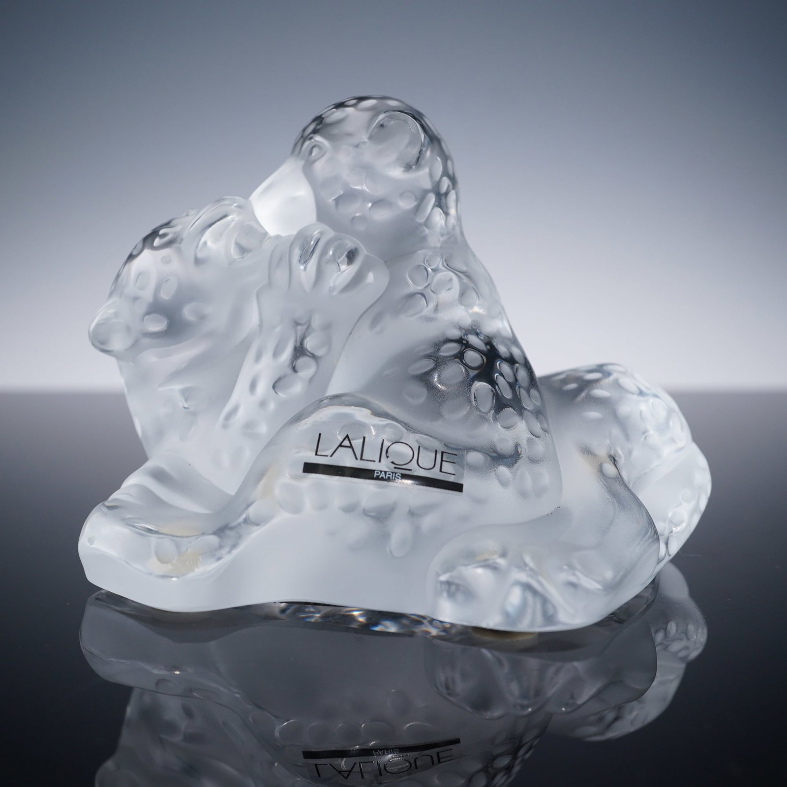 Lalique Crystal Figurine, Jaguar Cubs: Charming crystal sculpture of two jaguar cubs in a playful embrace, crafted in frosted crystal with polished details and a textured spotted surface. The design conveys energy and affection with a sens