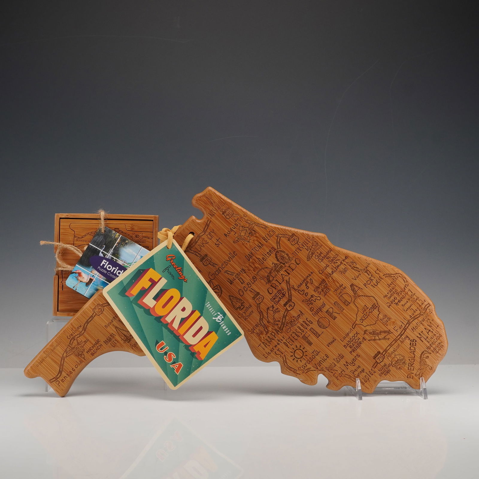 2pc Florida Bamboo Puzzle Coaster Set and State Map Board: A distinctive 2-piece set celebrating the Sunshine State, crafted from eco-friendly bamboo. The first piece is a Florida puzzle coaster set neatly housed in a bamboo box, etched with a state map and m