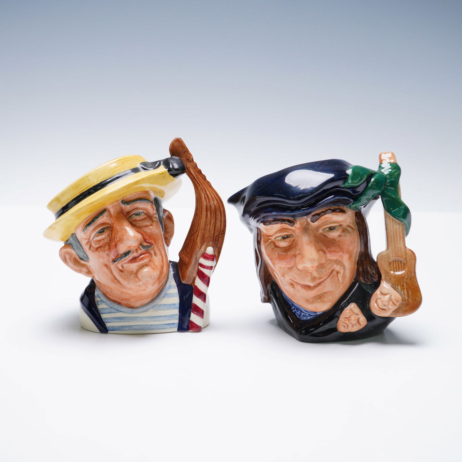 2pc Royal Doulton Small Character Jugs, Scaramouche D6561 & Gondolier D6592: A pair of Royal Doulton small character jugs featuring Scaramouche D6561, designed by David B. Biggs and issued in 1962, and Gondolier D6592, designed by Max Henk and issued in 1964. Both jugs are han