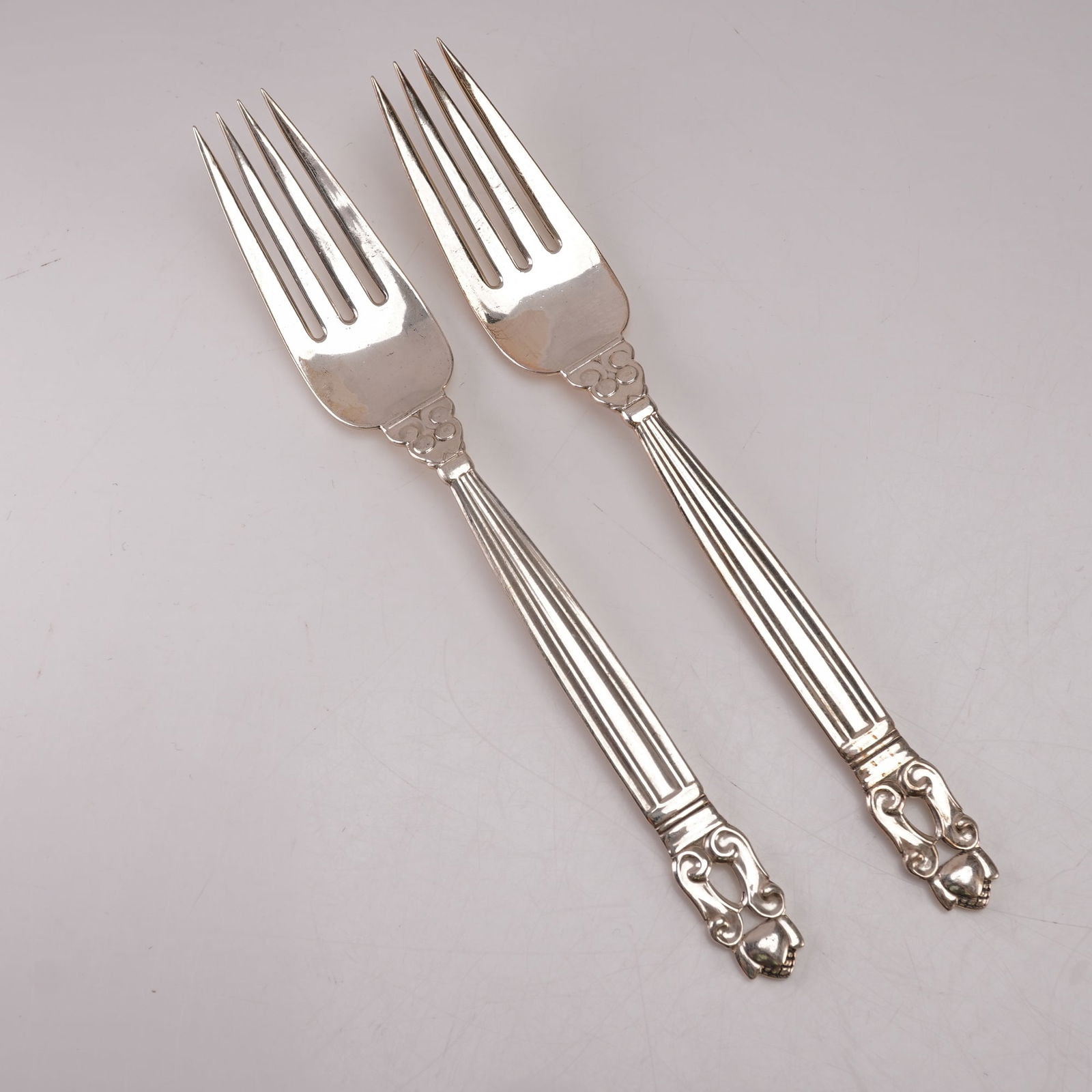 2pc Georg Jensen Sterling Silver Luncheon Forks, Acorn: A two piece lot of Georg Jensen sterling silver luncheon forks in the Acorn pattern, designed by Johan Rohde. Each bears the Georg Jensen hallmark and is stamped Sterling Denmark. The pattern features