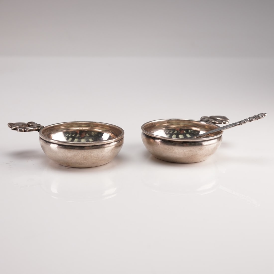 3pc Georg Jensen Sterling Silver Salt Sellars and Spoon, Acorn: A distinguished three-piece Georg Jensen sterling silver open salt set in the celebrated Acorn pattern, designed by Johan Rohde. The set includes two open salt cellars and a matching salt spoon, each