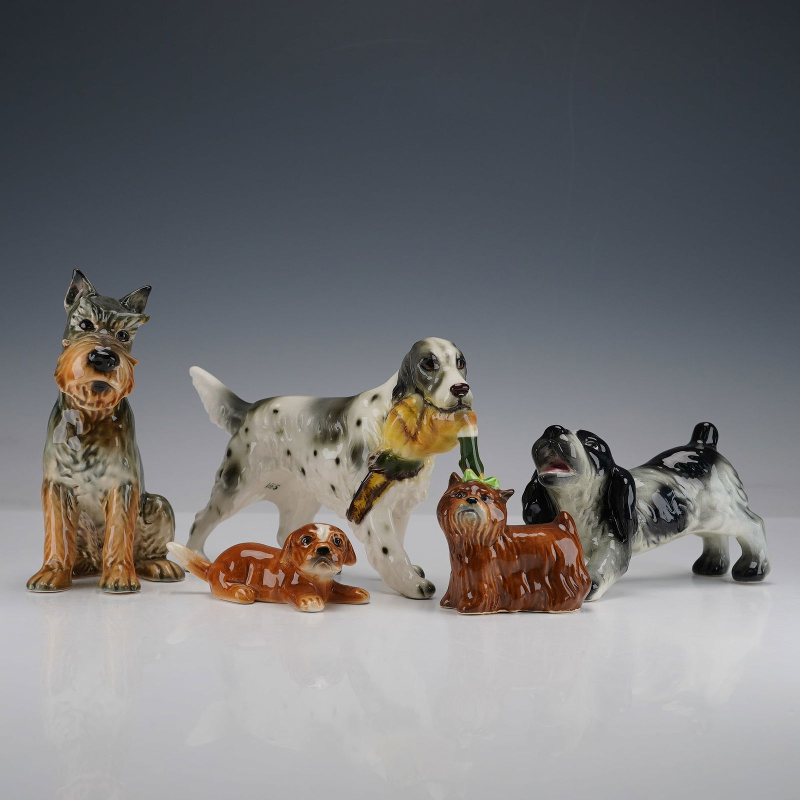 5pc Goebel Dog Figurines- English Setter, Schnauzer, Spaniel + More: Collection of five finely crafted Goebel porcelain dog figurines representing a variety of beloved breeds including an English Setter with Pheasant (not marked Goebel), Schnauzer, and Spaniel among ot