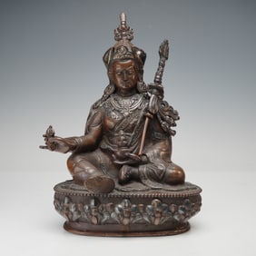 Tibetan Bronze Seated Deity with Silver Overlay
