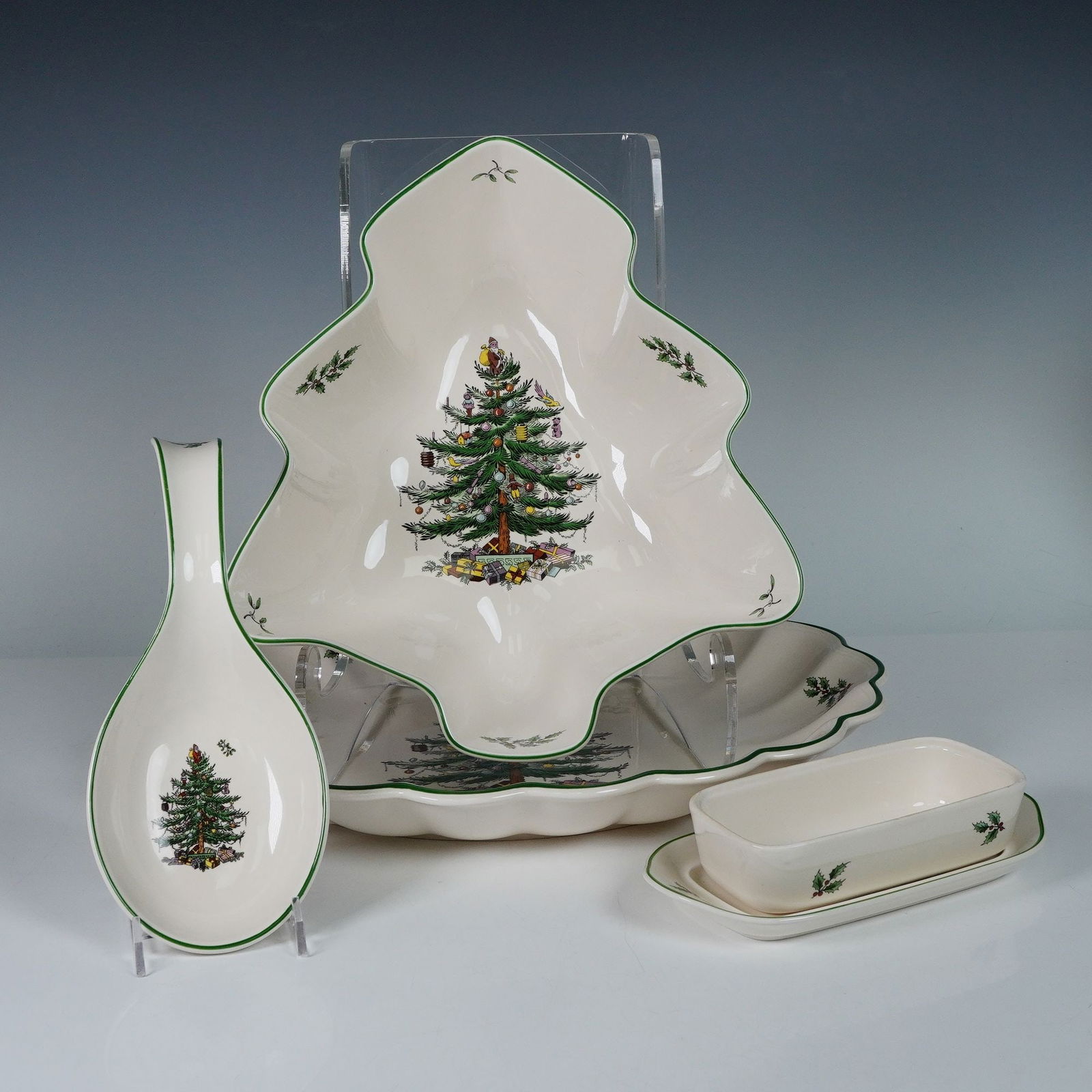 4pc Spode Christmas Tree Serveware Set: A festive 4-piece Spode serveware grouping from the classic Christmas Tree pattern, including a tree-shaped bowl, an oval scalloped platter, a spoon rest, and a 2-piece covered butter dish. Each piece