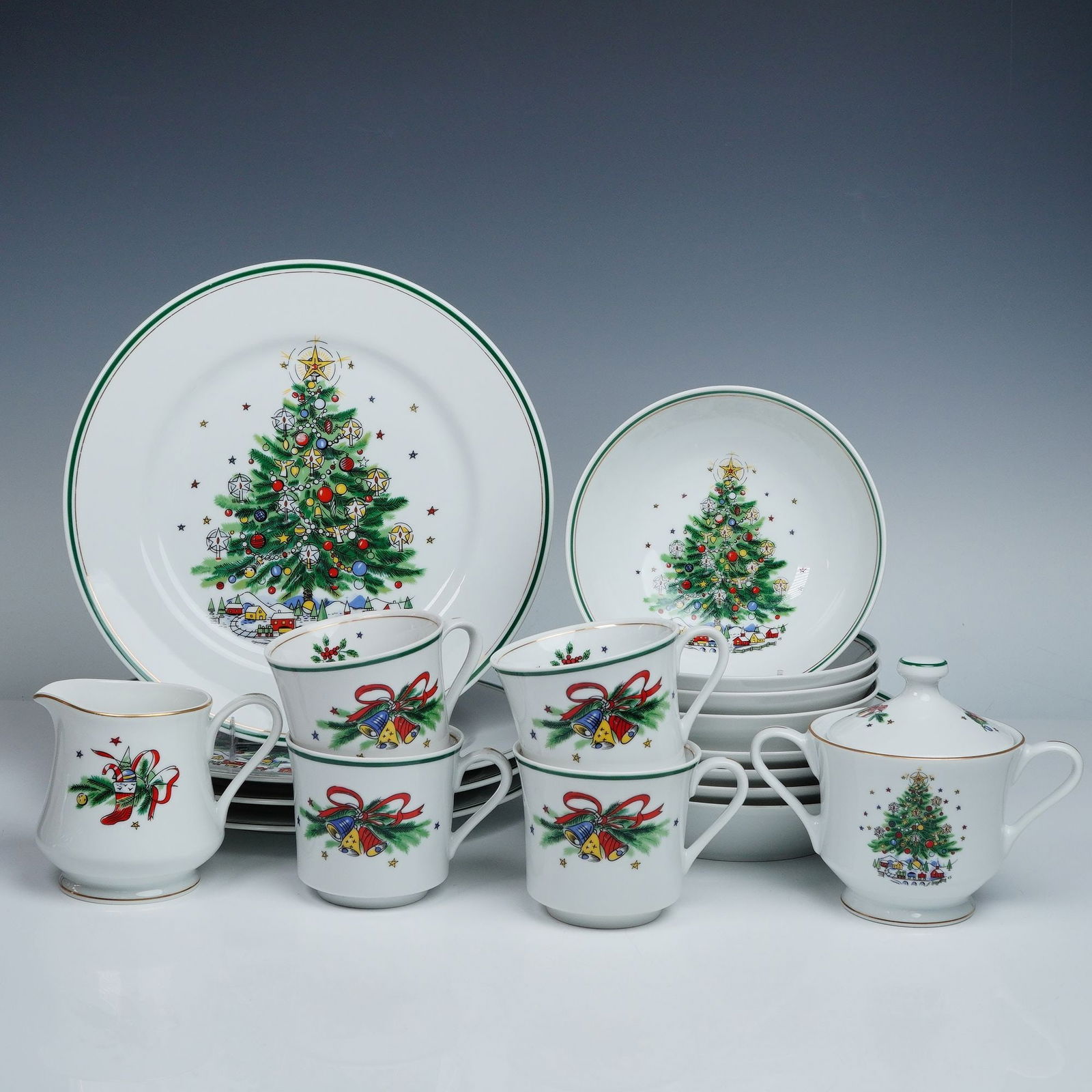 18pc Salem Porcelain China Christmas Eve Dinnerware Set: A festive 18-piece Salem Porcelain China Christmas Eve dinnerware set featuring colorful decorated Christmas trees, ribbons, bells, and gift motifs. The set includes four dinner plates, four coupe cer