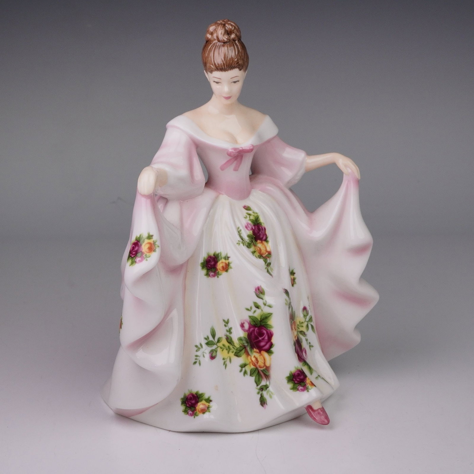 Royal Doulton Pretty Ladies Figurine, Kathryn HN4948: A Royal Doulton Pretty Ladies figurine titled Kathryn, model HN4948. Issued in 2006, this hand-decorated bone china figure portrays an elegant lady in a flowing pink and white gown, patterned with clu