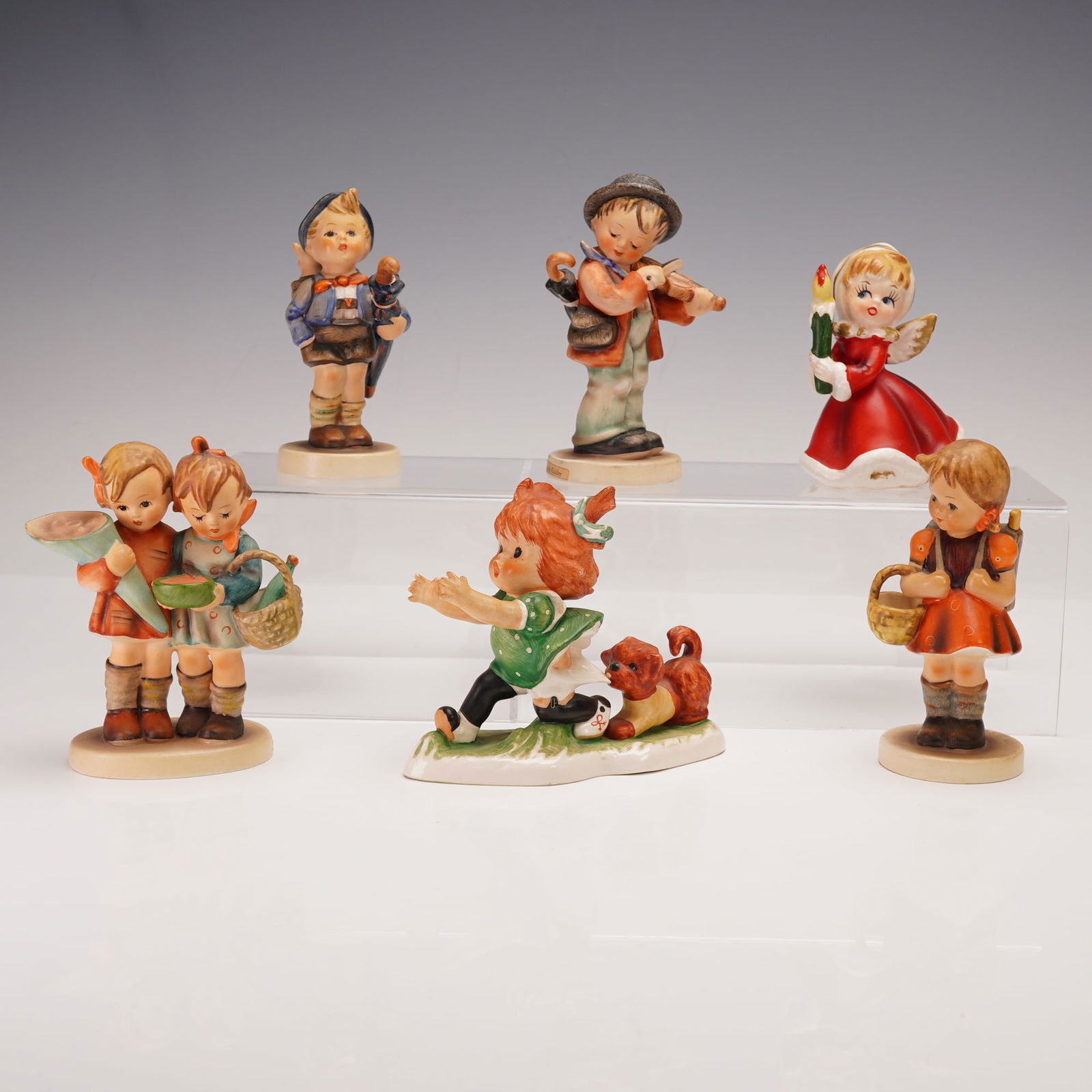 6pc Goebel Hummel Porcelain Figurines Including Napco Christmas Angel: Charming collection of six vintage figurines featuring five Goebel Hummel pieces and one Napco Christmas angel. The Goebel Hummel group includes Charlotte BYJ9, Going to Grandma's No. 52, School Girl