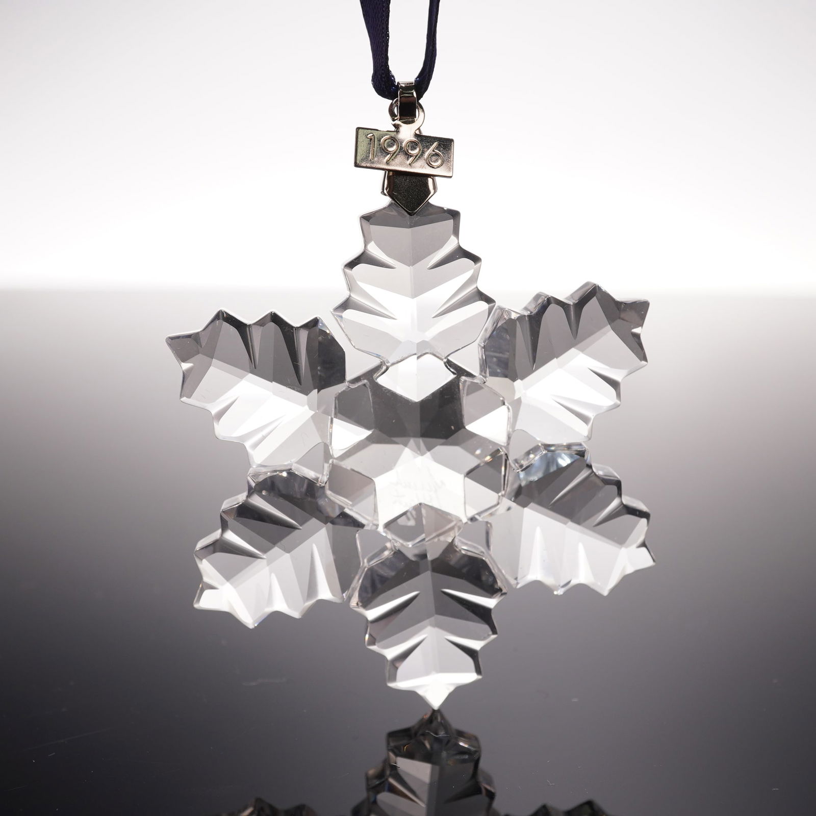 Swarovski Crystal 1996 Christmas Ornament: Swarovski 1996 Christmas Ornament 199734 crafted in clear faceted crystal with snowflake design and hanging ribbon, features Swarovski backstamp, includes original box 5.25"H. Artist: Martin Zendron I