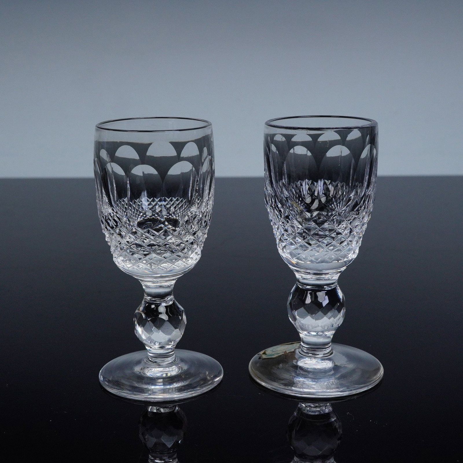 2pc Waterford Crystal Colleen Cordial Glasses: A beautiful pair of Waterford Colleen crystal cordial glasses, presented in their original Waterford box. Each glass is expertly hand-cut with a classic diamond and fan pattern, showcasing the brand's