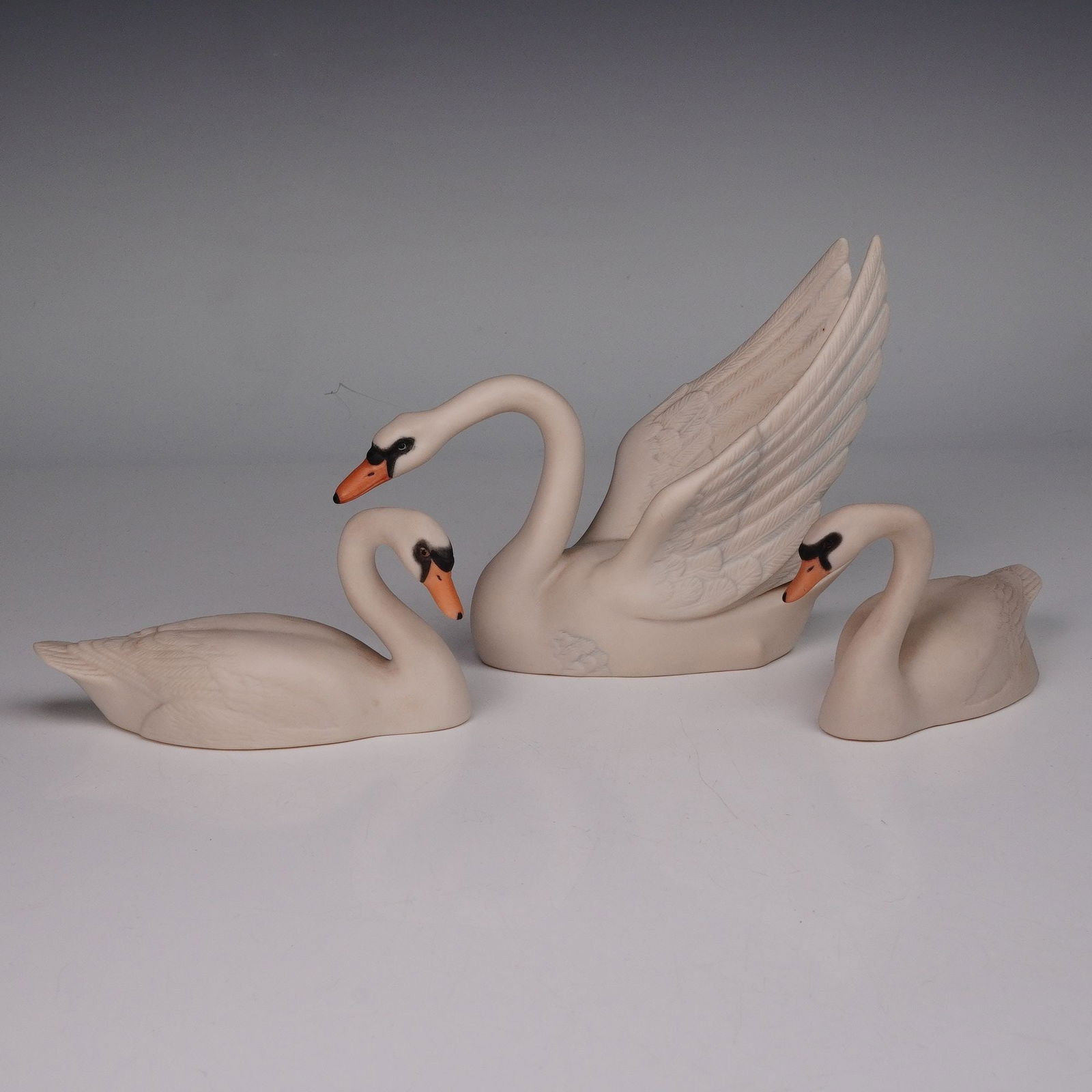 3pc Laszlo Ispansky for Goebel Figurines, Winged & Little Swans: A charming set of three Goebel porcelain swan figurines designed by Laszlo Ispansky. This grouping includes the elegant Winged Swan with detailed open wings and two smaller swans, one titled The Littl