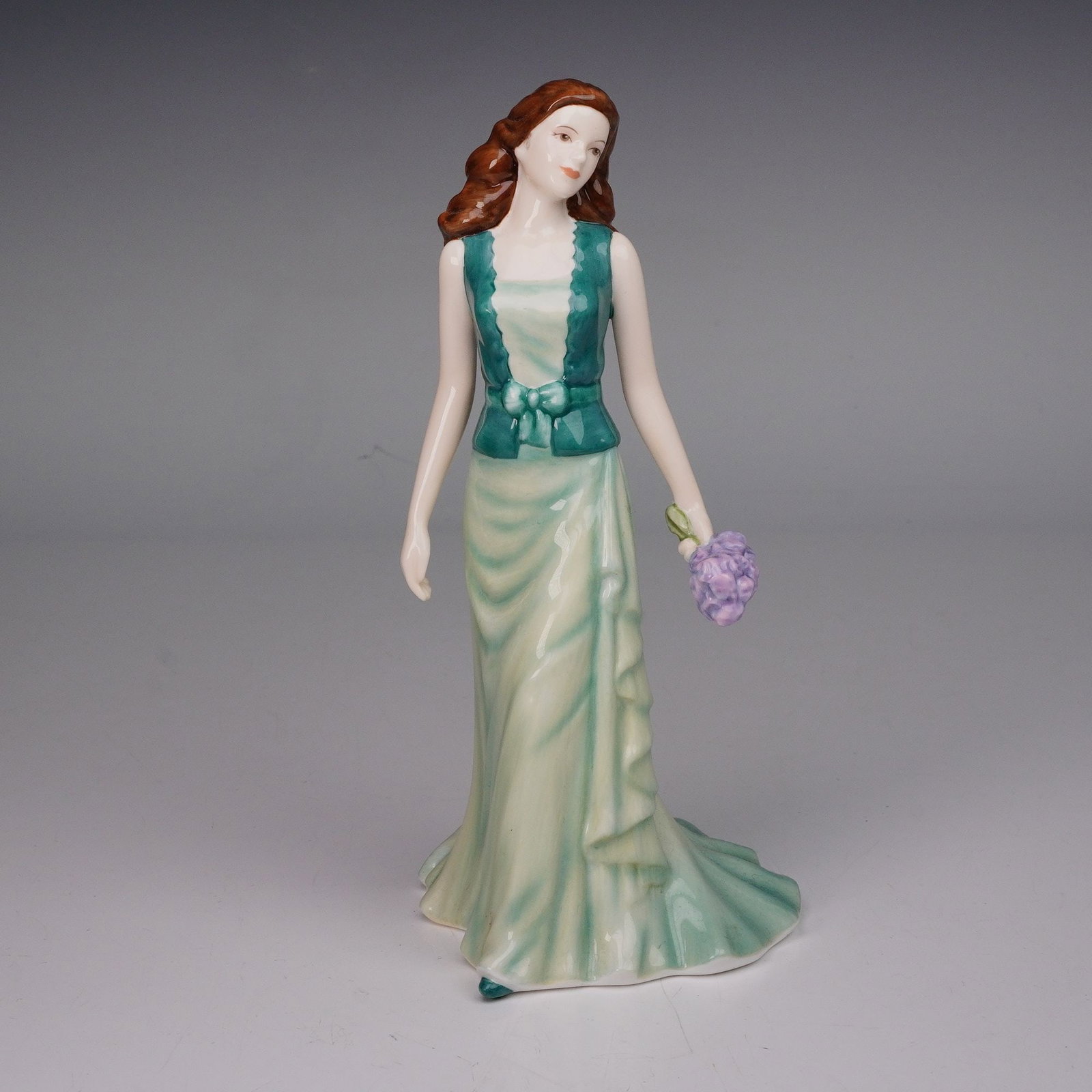 Royal Doulton Pretty Ladies Figurine, Loving Thoughts HN5266: Royal Doulton Pretty Ladies porcelain figurine titled Loving Thoughts (HN5266). This hand-made and hand-decorated piece features a graceful young woman in a flowing green gown with teal bodice trim, h