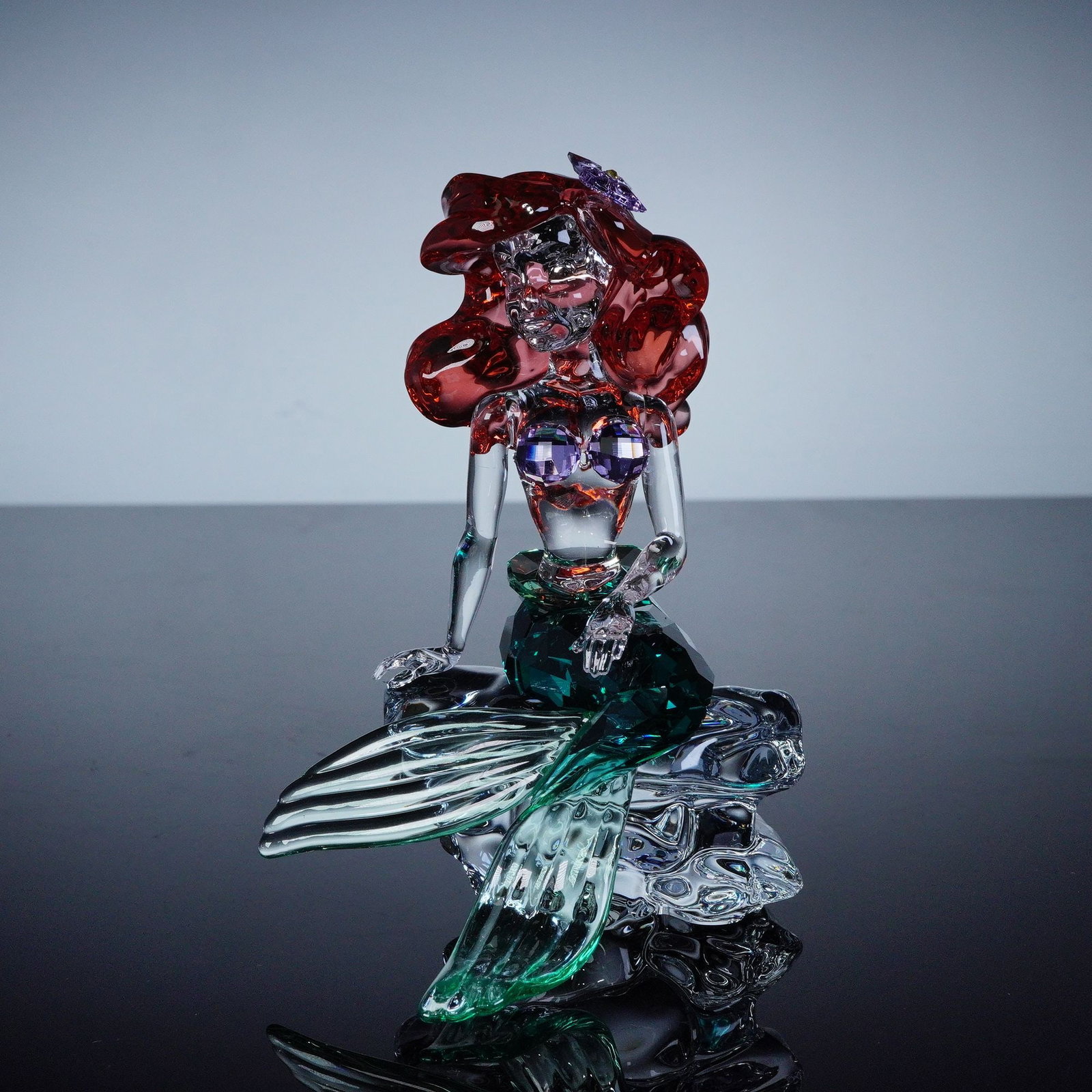 Swarovski Disney The Little Mermaid Crystal Figurine, Ariel: A beautifully crafted crystal figurine of Princess Ariel from Disney's The Little Mermaid. Ariel is crafted in stunning smooth and faceted crystal, from her signature red hair to her green-toned merma