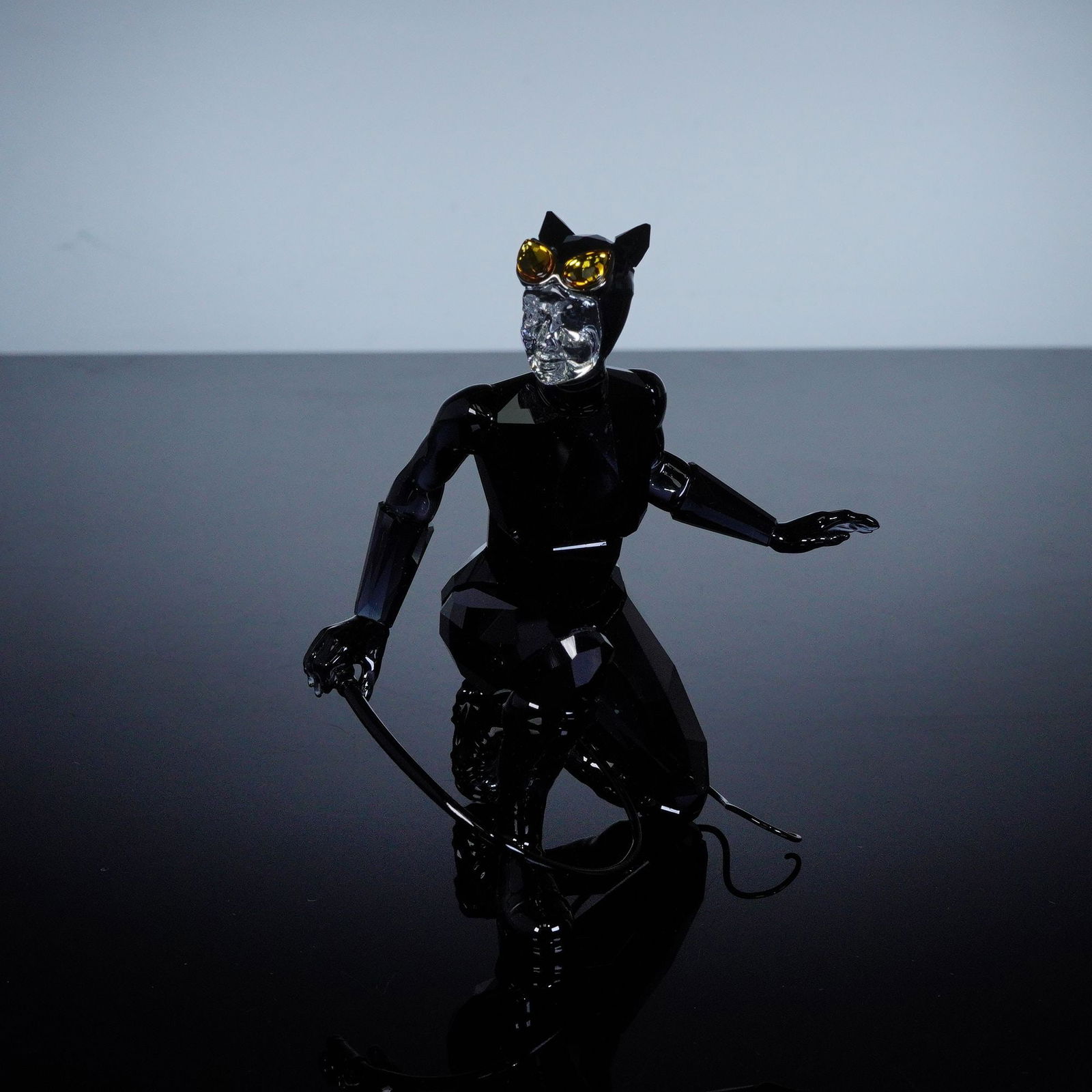 Swarovski DC Comics Crystal Figurine, Catwoman: A striking Swarovski crystal figurine portraying Catwoman, Gotham City's sleek and cunning antihero. Shown crouched and ready to strike, she is sculpted in faceted black crystal with accents of clear