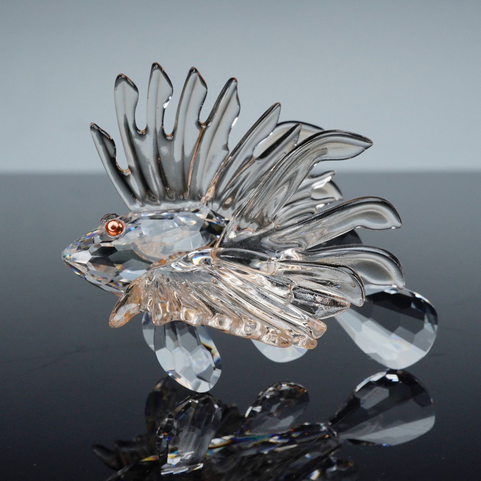 Swarovski Crystal Figurine, Lion Fish: Swarovski crystal figurine Lion Fish 604011, featuring clear faceted crystal with orange fins and crystal eyes. Beautifully detailed with dynamic movement and exceptional brilliance. Etched with the S